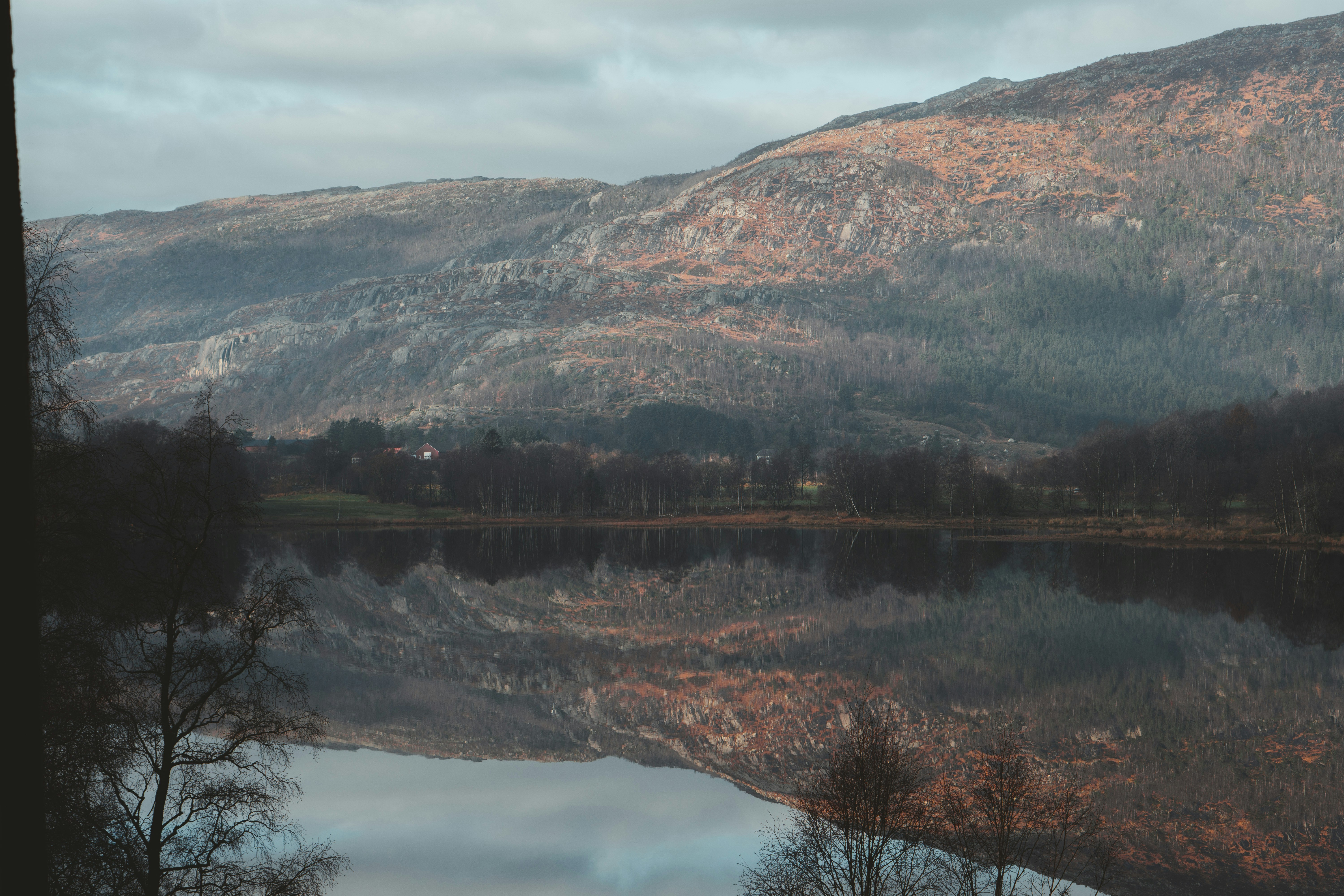 brown and green mountains beside lake during daytime