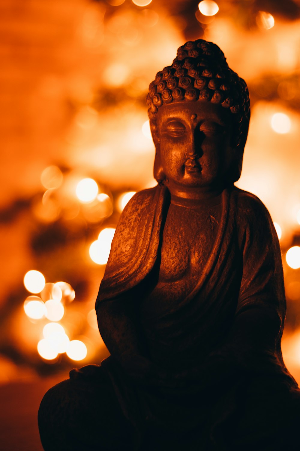 black buddha statue in close up photography