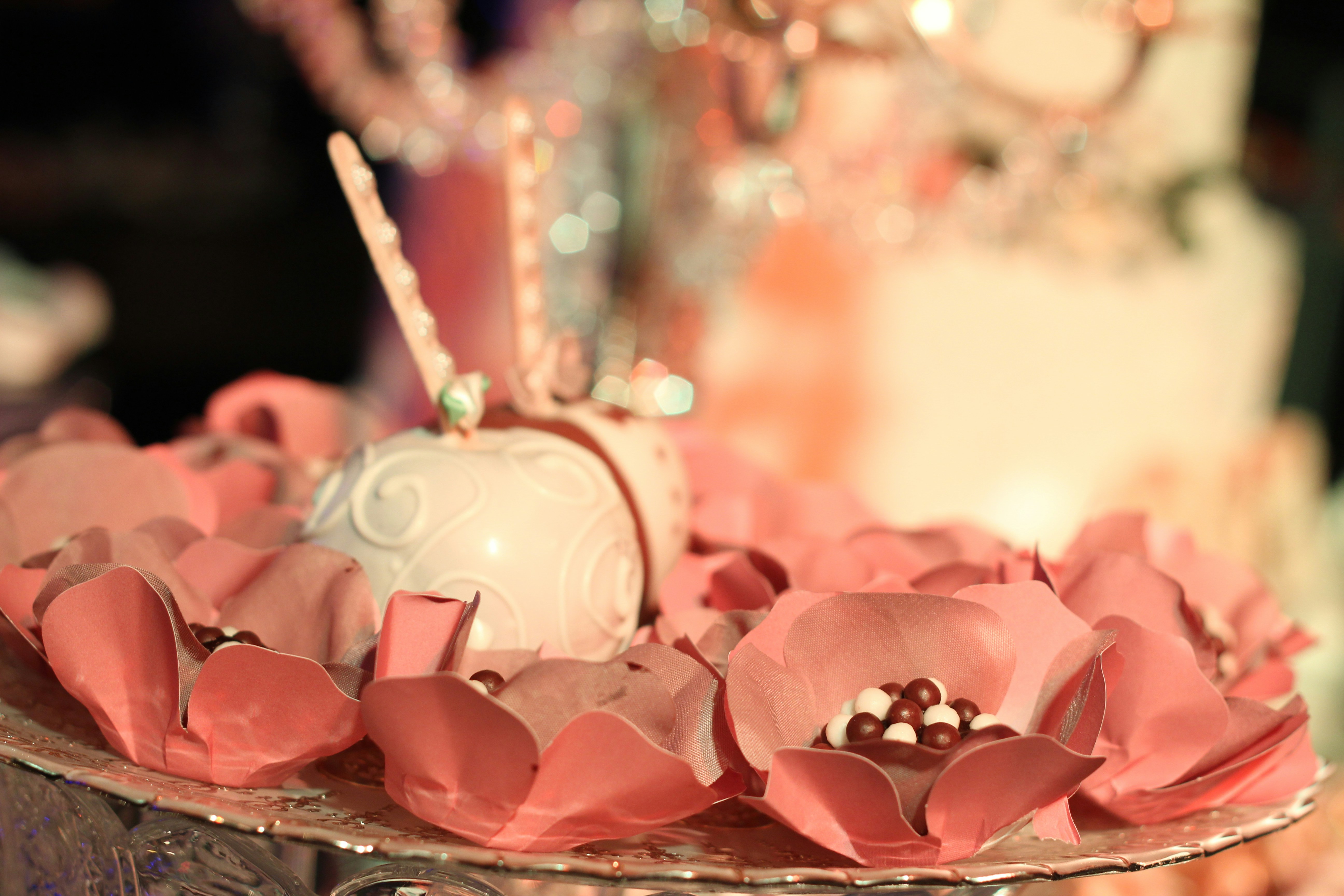 pink and white cupcake with pink ribbon on top