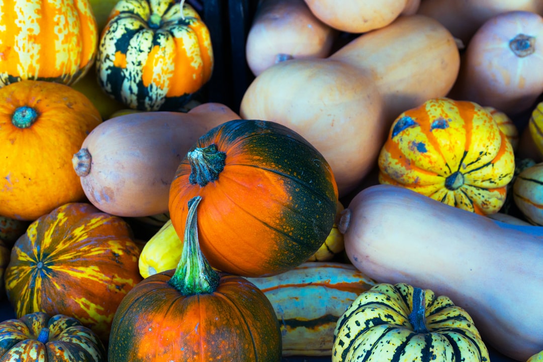 yellow and green pumpkin on brown wooden table, Winter squash at the farmers market.