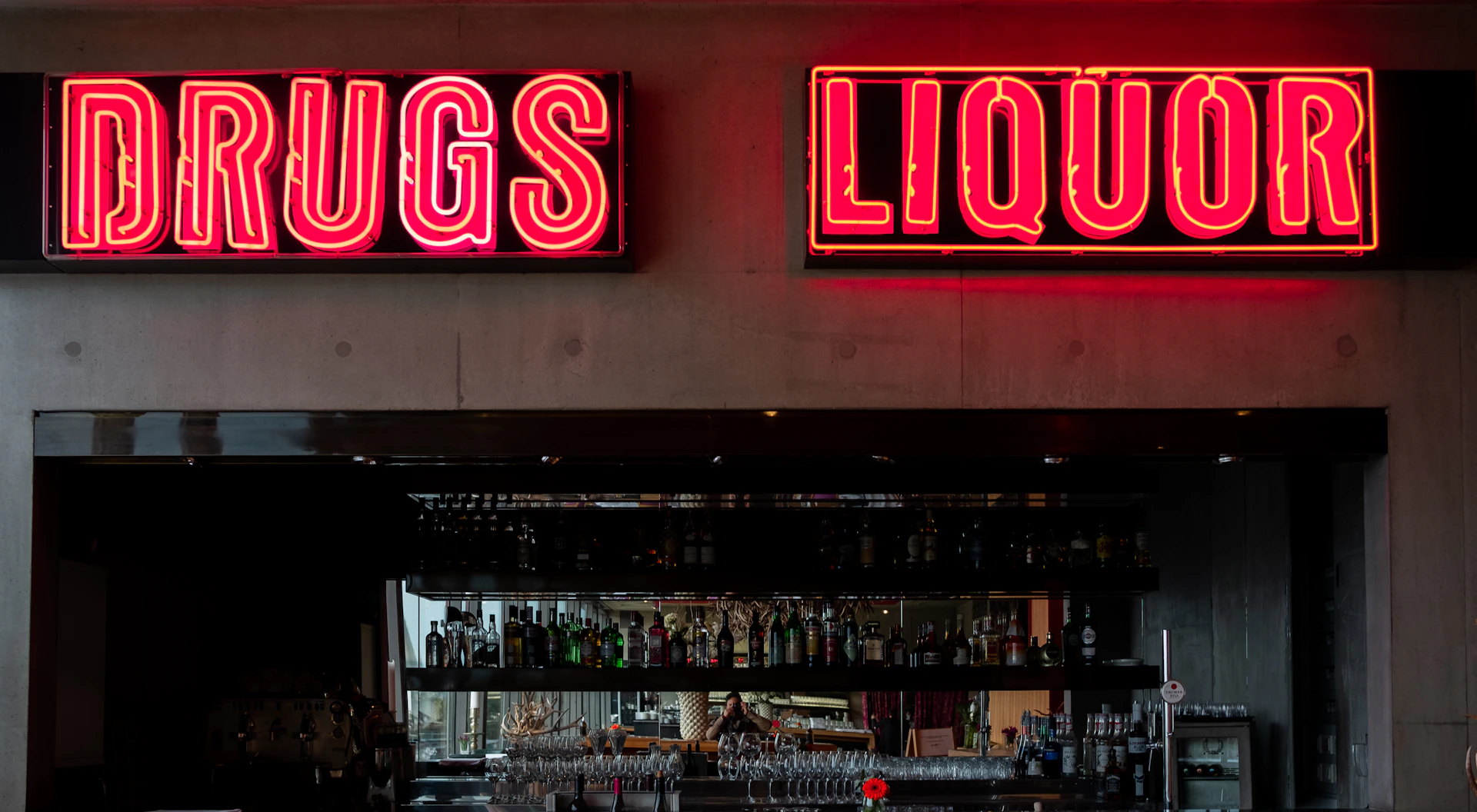 a liquor store with neon signs above the bar
