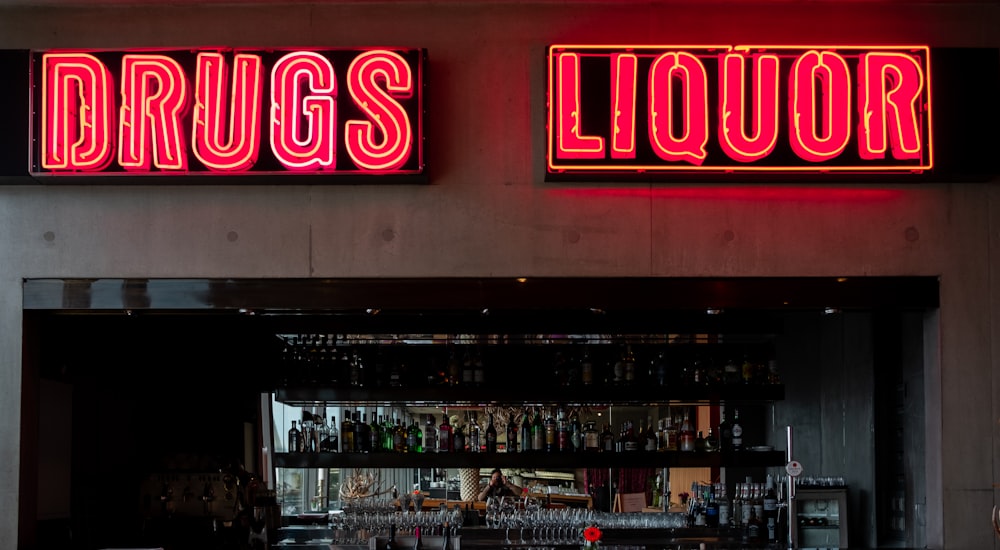a liquor store with neon signs above the bar