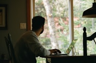 man in gray hoodie using laptop computer