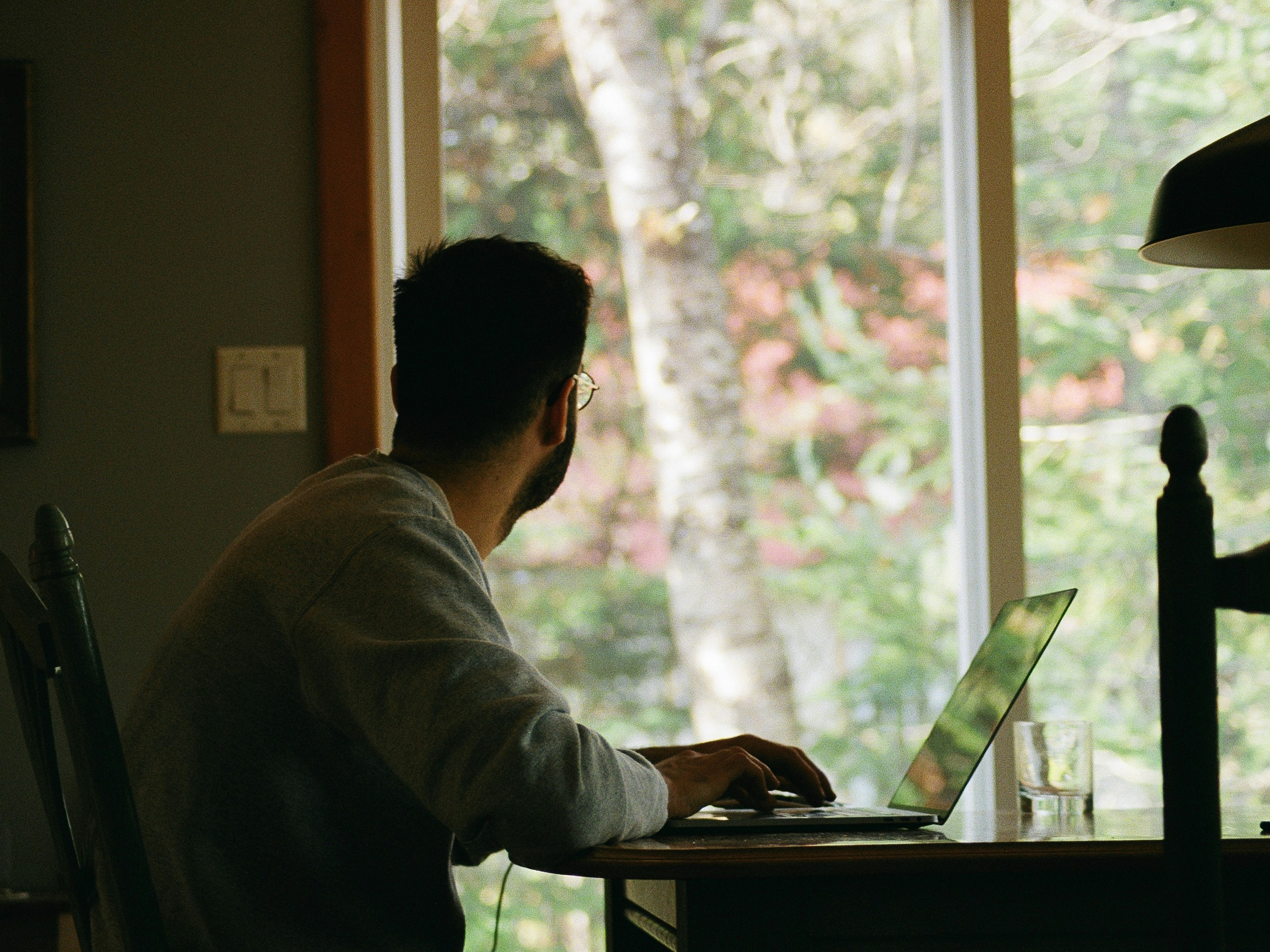 man in gray hoodie using laptop computer