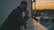 man in black long sleeve shirt sitting by the table