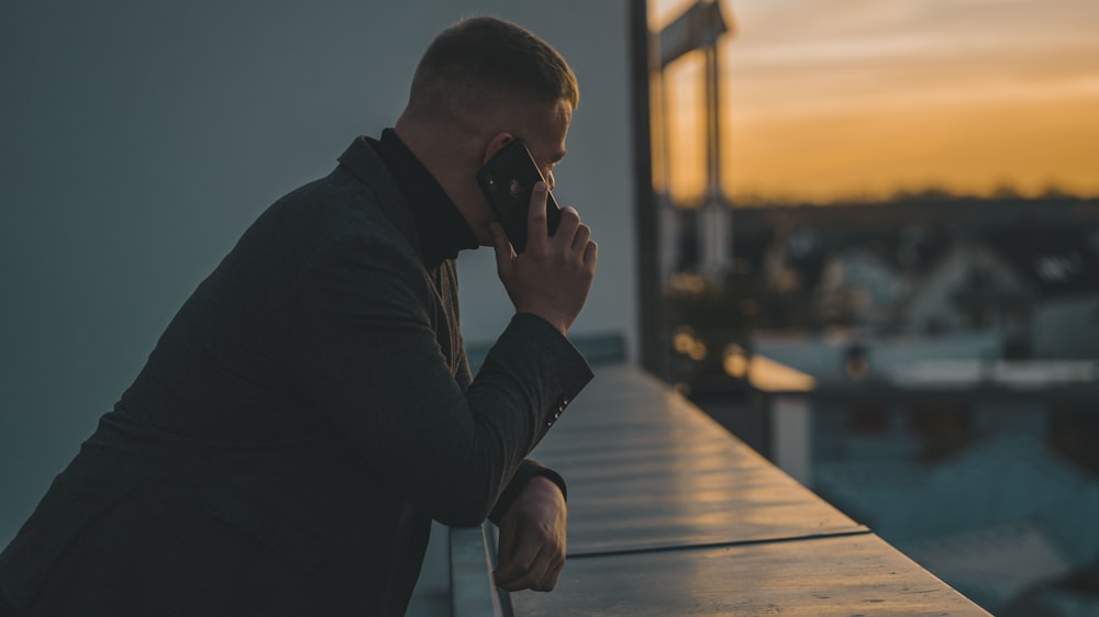 man in black long sleeve shirt sitting by the table