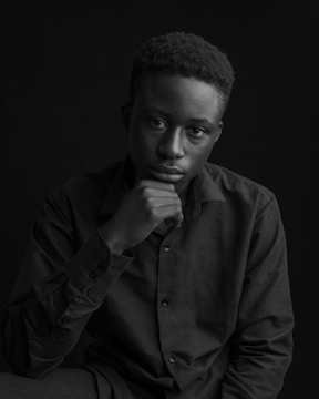 A sleek executive portrait with cinematic lighting and a dark, minimalist background.