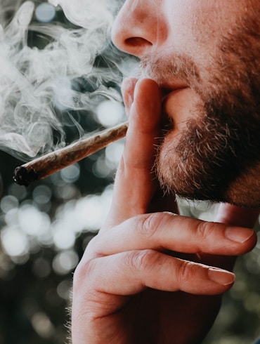 man smoking cigarette during daytime