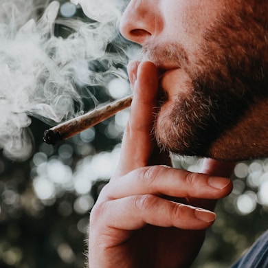 man smoking cigarette during daytime