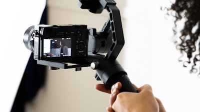 person holding black video camera