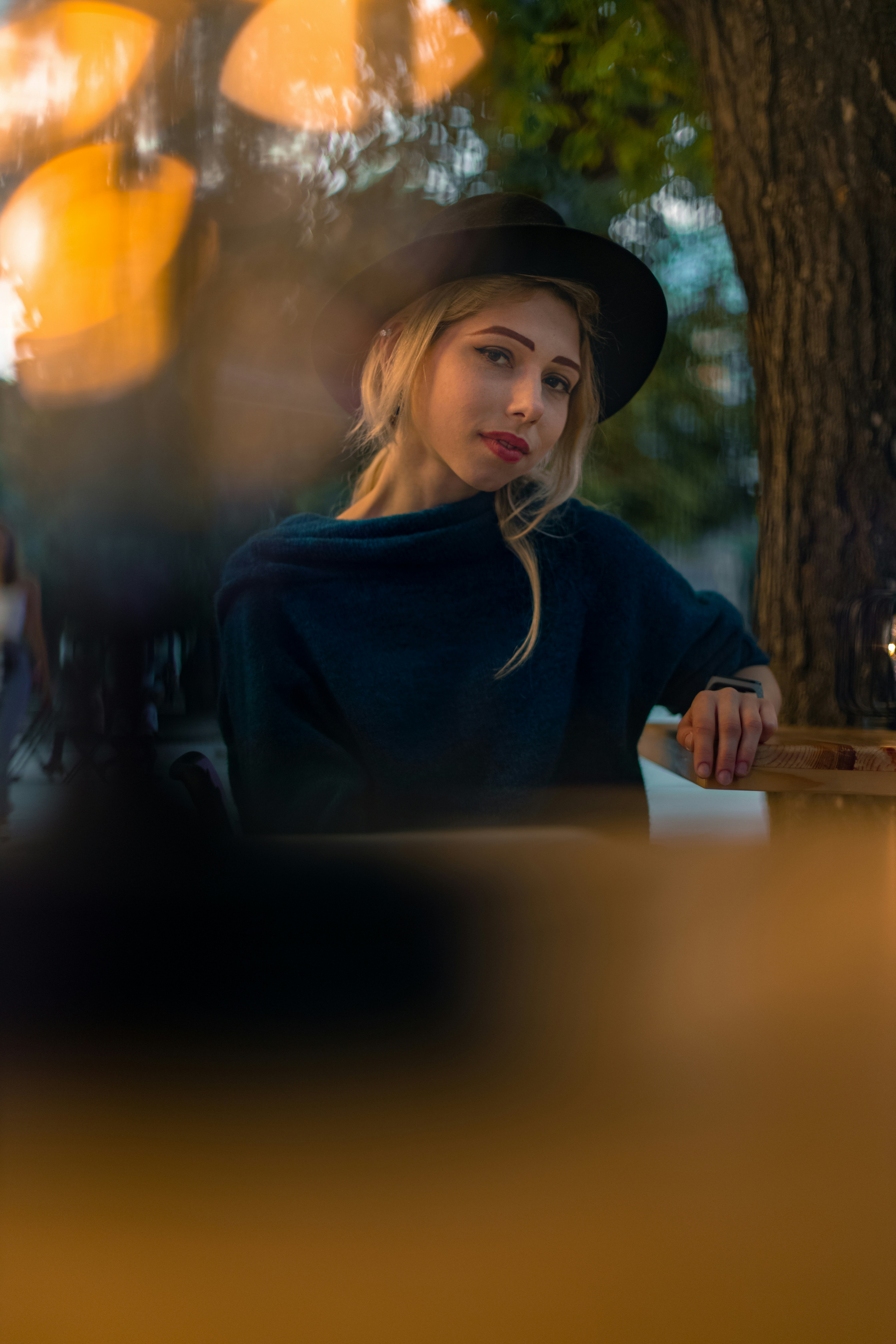 woman in black long sleeve shirt wearing black hat