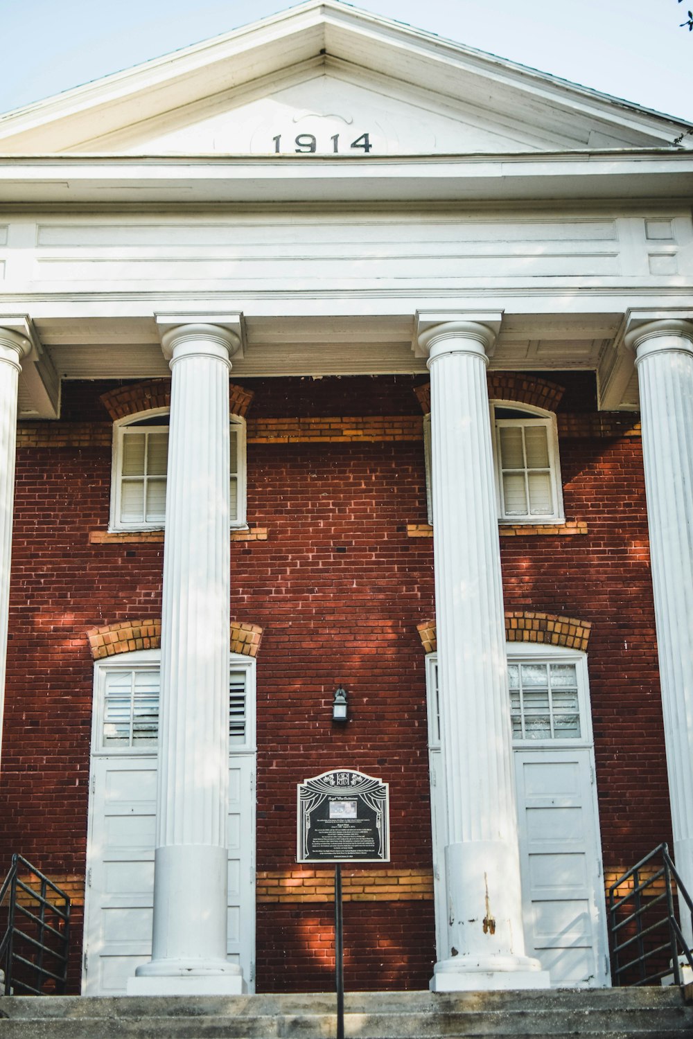 brown brick building with white wooden door