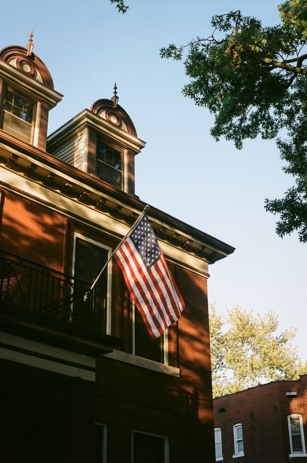us a flag on brown wooden house
