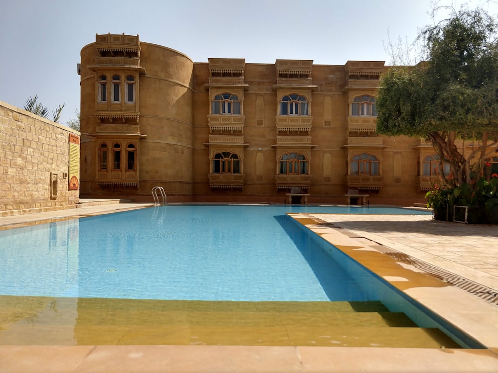 swimming pool near brown building during daytime