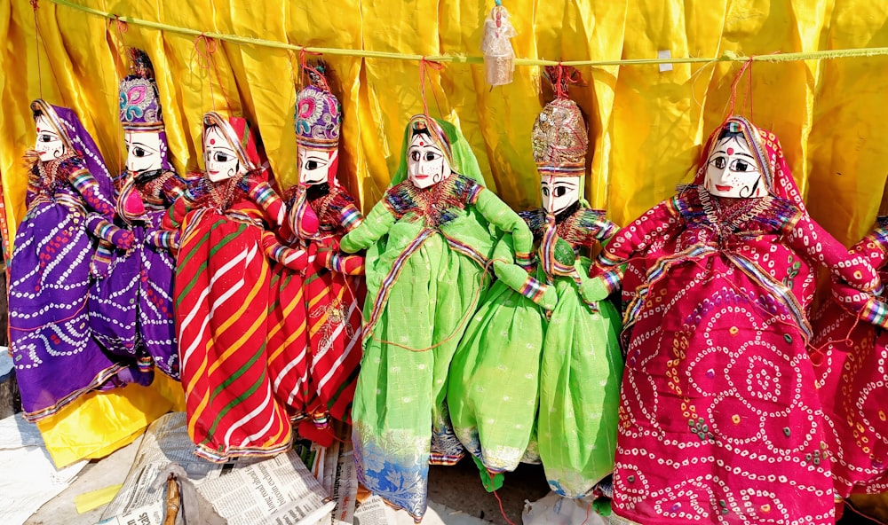 man in green traditional dress standing beside woman in red and white dress