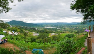 A panoramic view of the Yovi Industries factory nestled in the green hills of Kullu, with workers assembling premium tents.