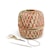 A multicolored ball of yarn is placed alongside a pair of small scissors and a crochet hook. The yarn features a pattern with red, green, and white strands intricately wrapped around in layers. The scissors have metal blades and golden handles, while the crochet hook is silver and slender.