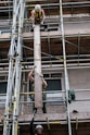 man in black shorts on brown metal ladder