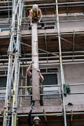 man in black shorts on brown metal ladder