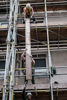 man in black shorts on brown metal ladder