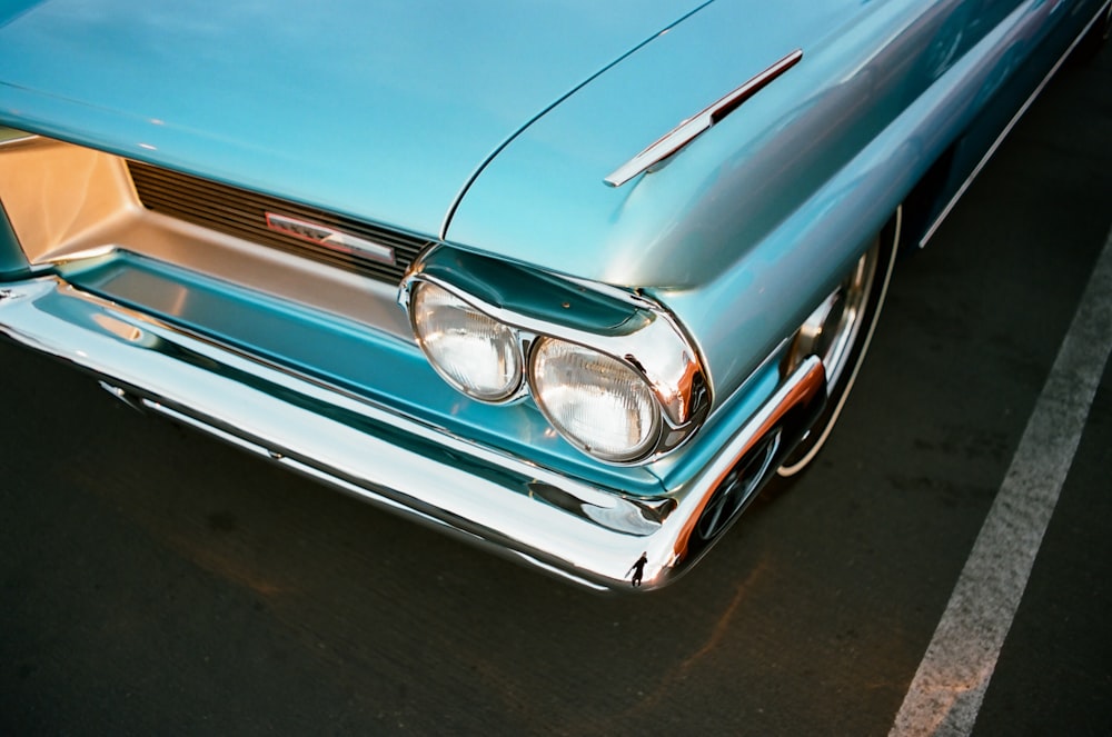 blue and white car on black asphalt road