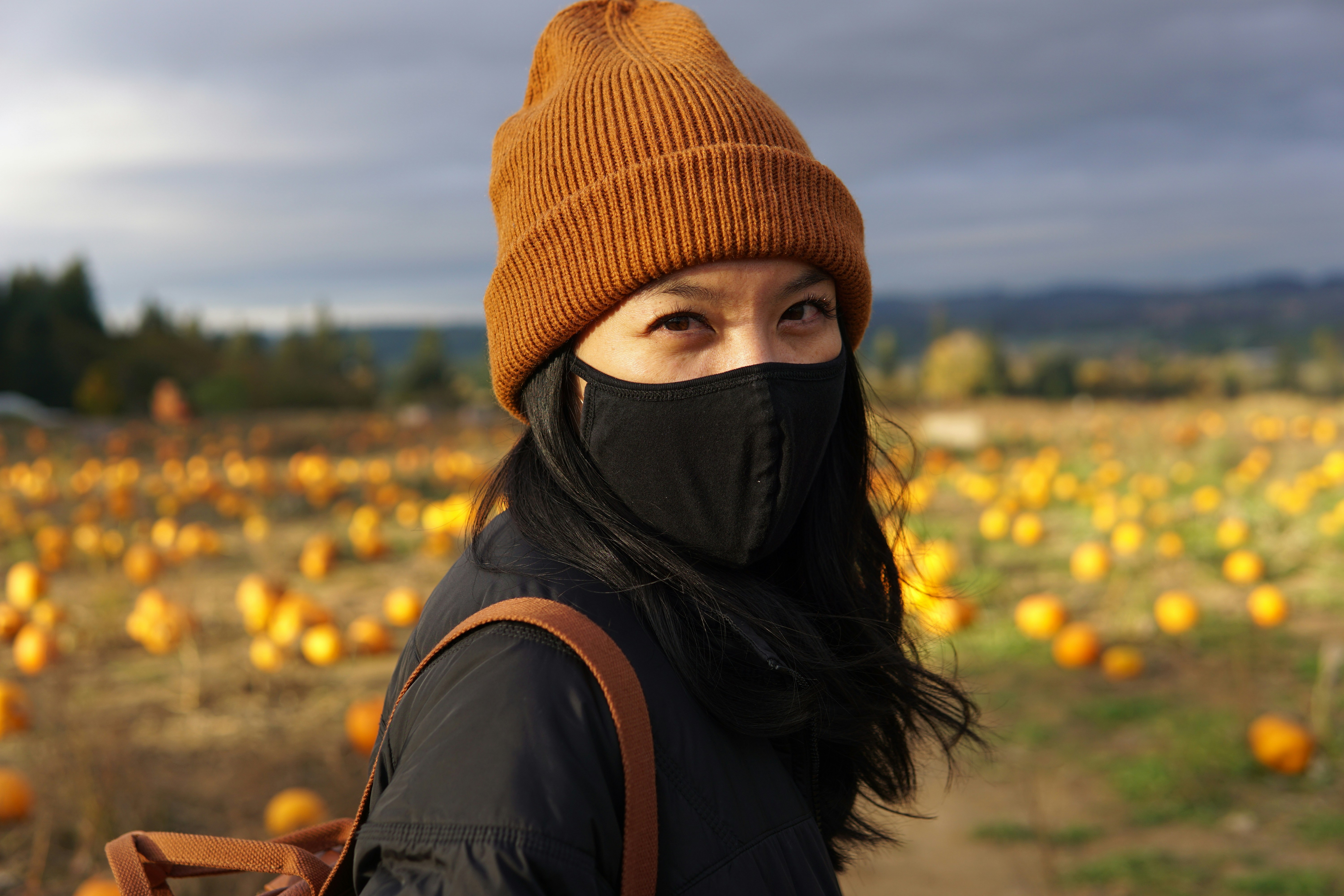 woman in brown knit cap and black hijab
