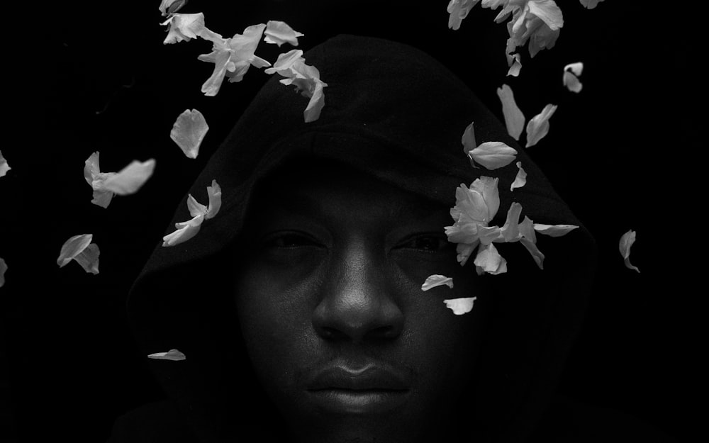 grayscale photo of woman with white flower on her head