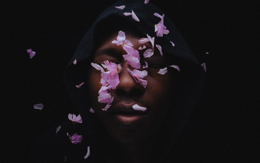 woman with purple and white flower on her face