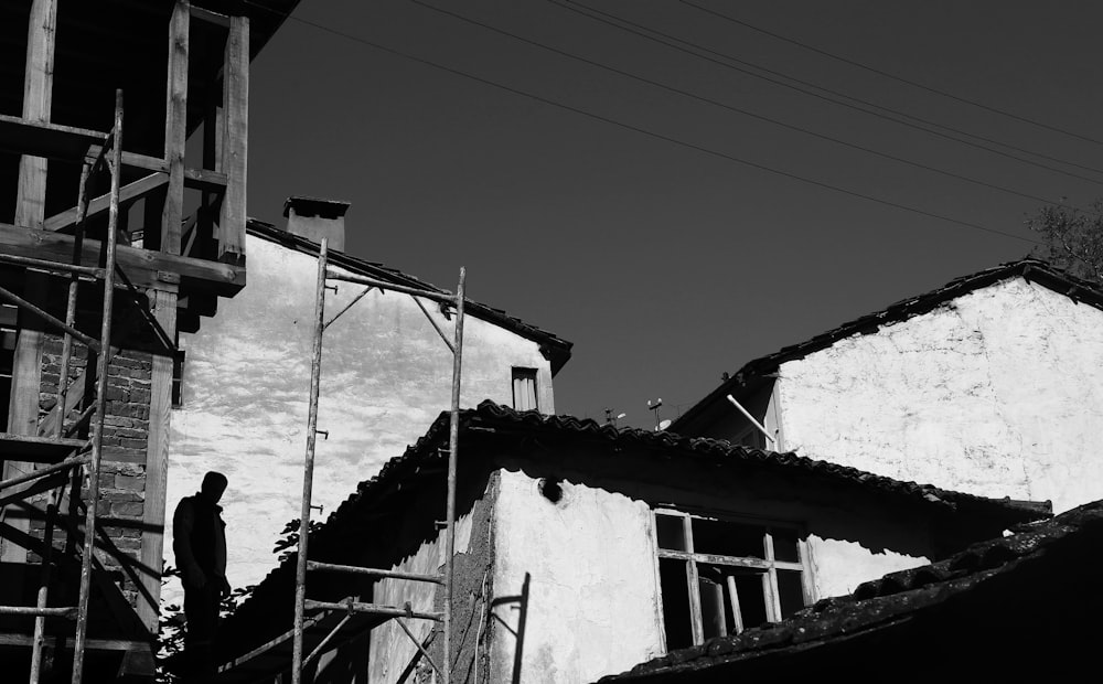 grayscale photo of man standing on stairs