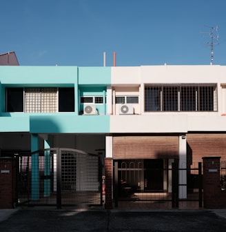 green and white concrete building under blue sky during daytime