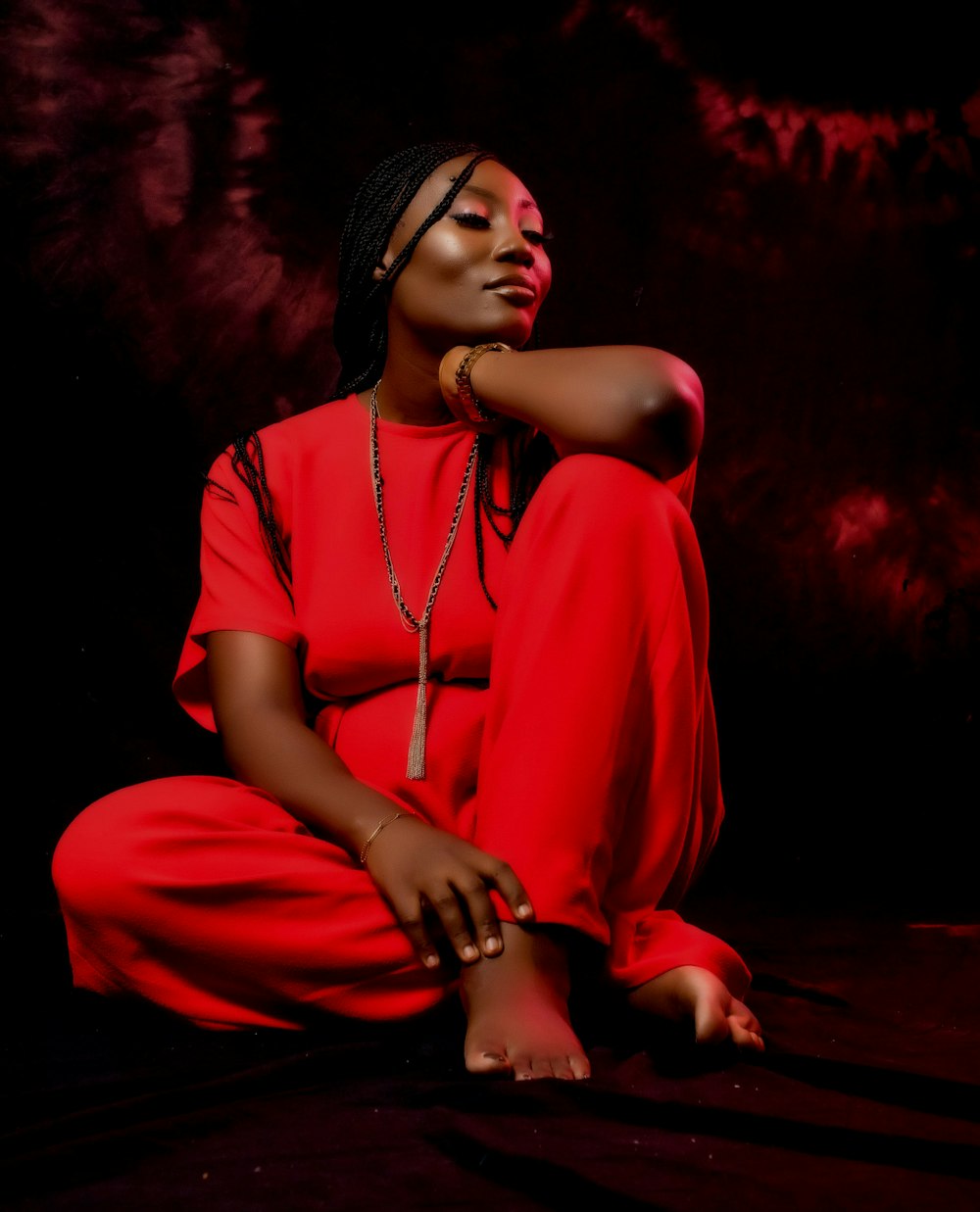 woman in red dress sitting on floor