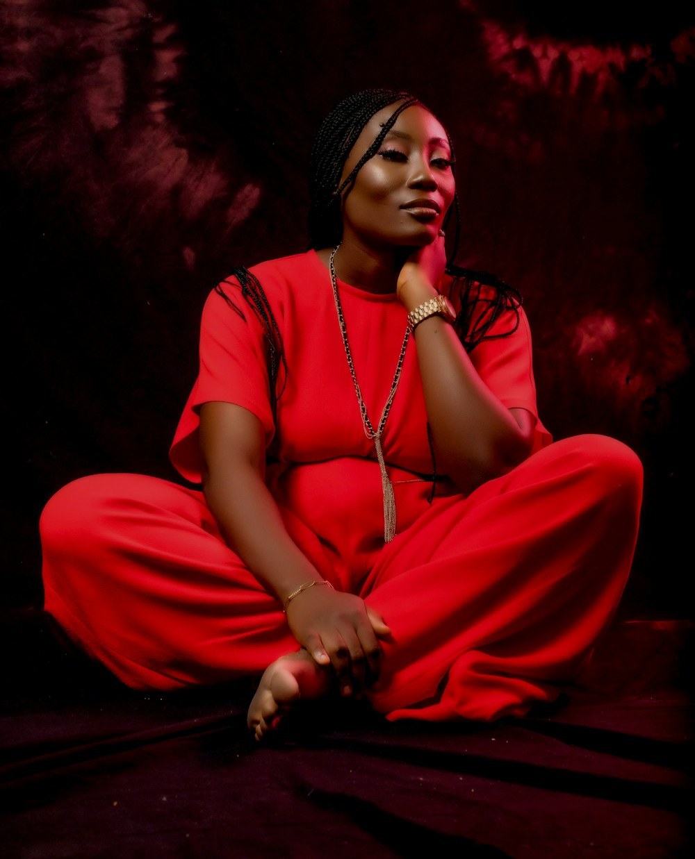 woman in red dress sitting on red textile