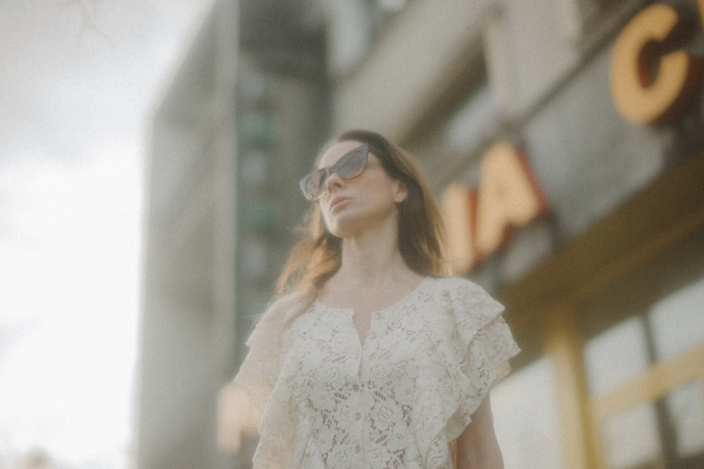 woman in white floral dress wearing sunglasses