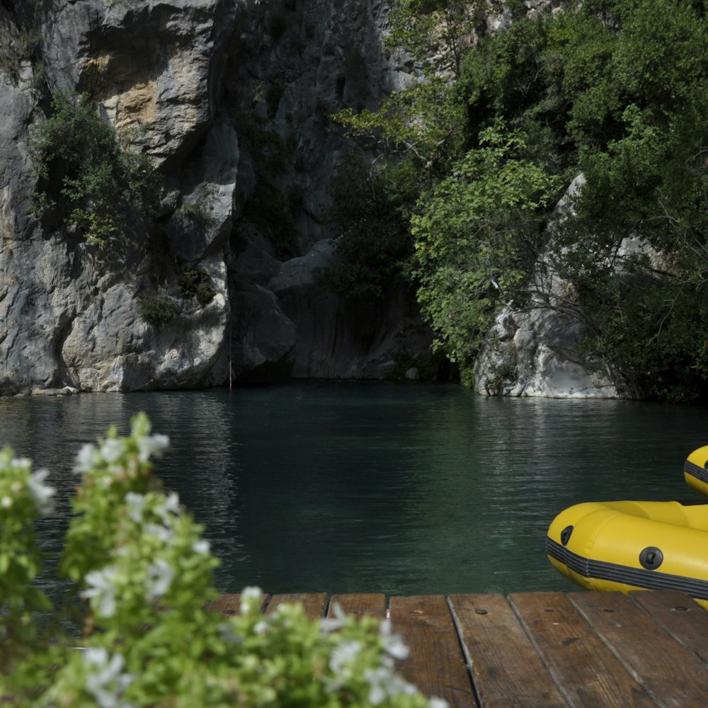 yellow kayak on brown wooden dock during daytime