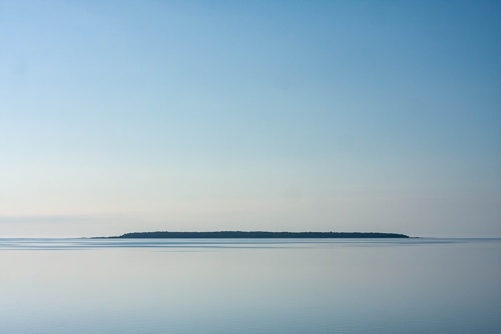 calm sea under blue sky during daytime