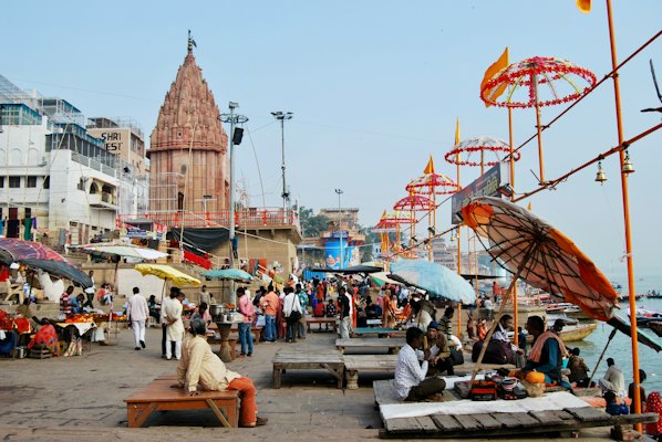 People sitting on bench near brown concrete building during daytime — Varanasi, India