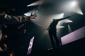 A talented artist performing on stage, captivating the audience.
