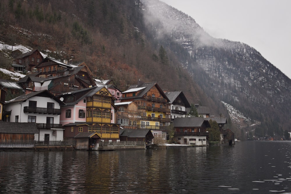 houses near body of water and mountain