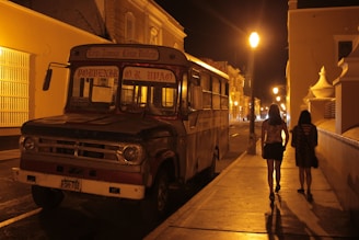 A cozy evening scene of the shuttle bus parked at a charming Florida bed and breakfast during an overnight trip.