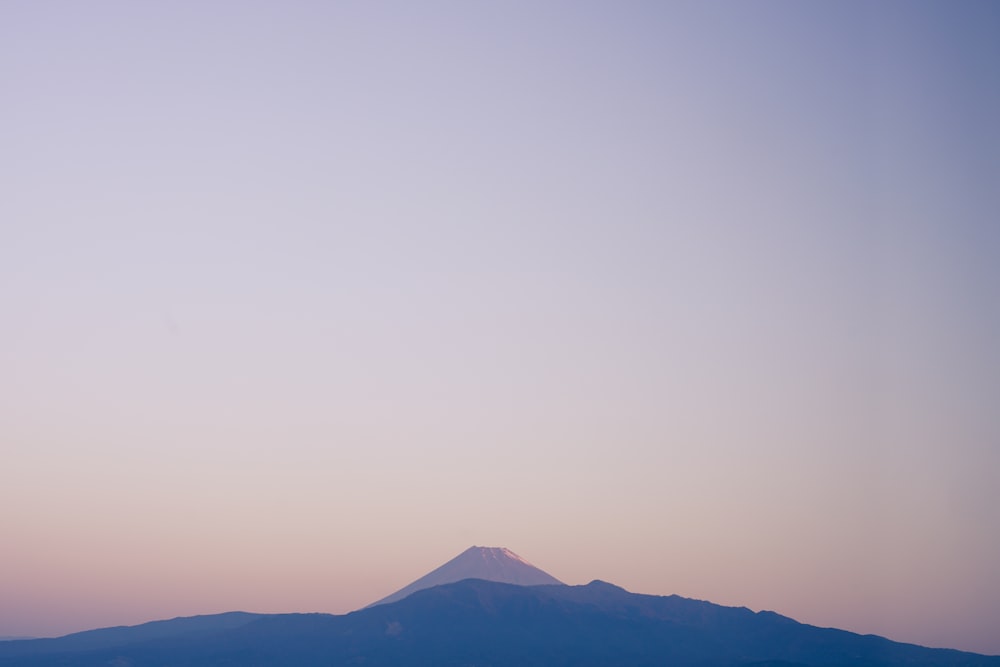 silhouette of mountain under white sky during daytime