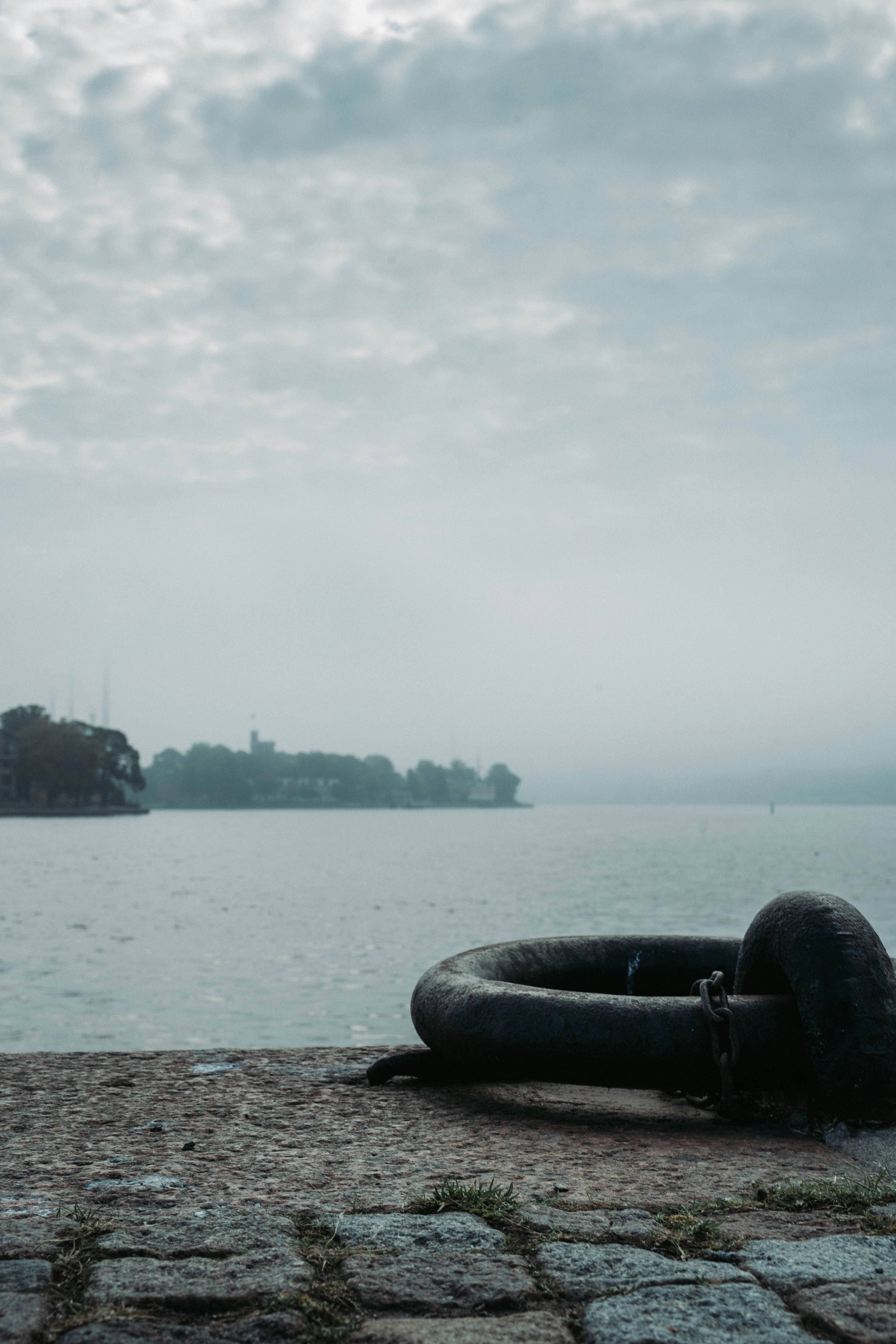 black car tire on gray sand near body of water during daytime