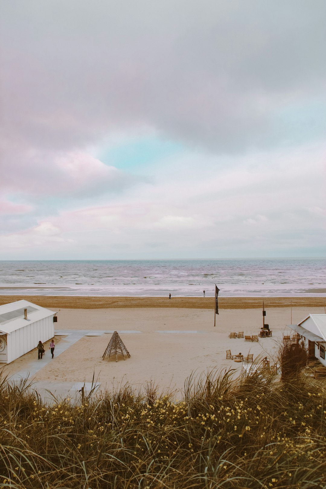 white wooden house on beach during daytime