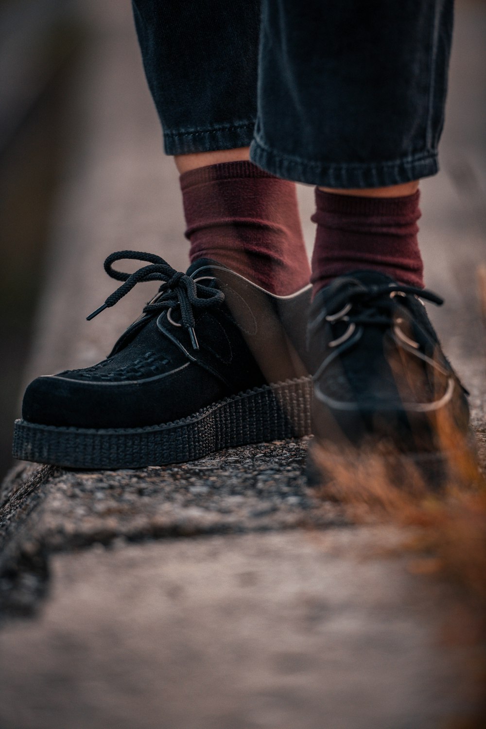 person wearing black and white nike sneakers