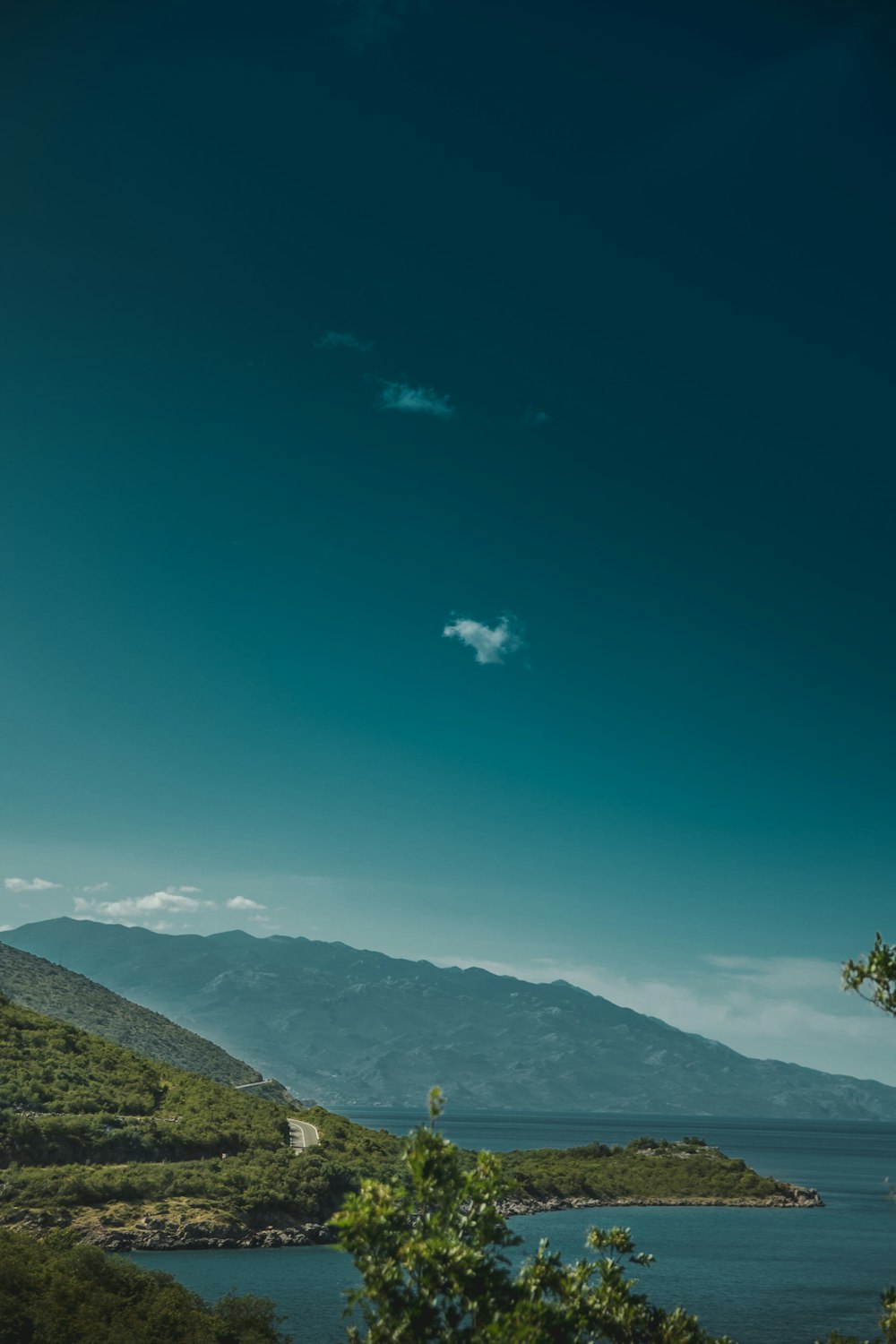 green trees on mountain under blue sky during daytime