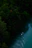 A serene river scene with a lone kayaker navigating through misty Canadian wilderness.