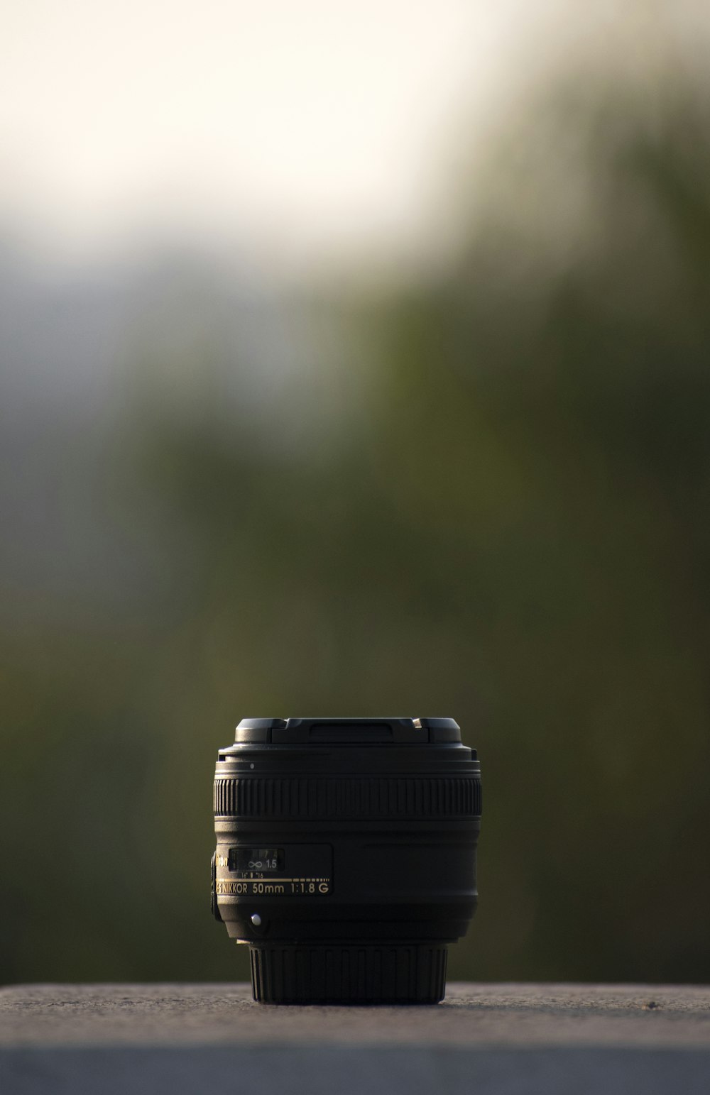 black camera lens on brown wooden table