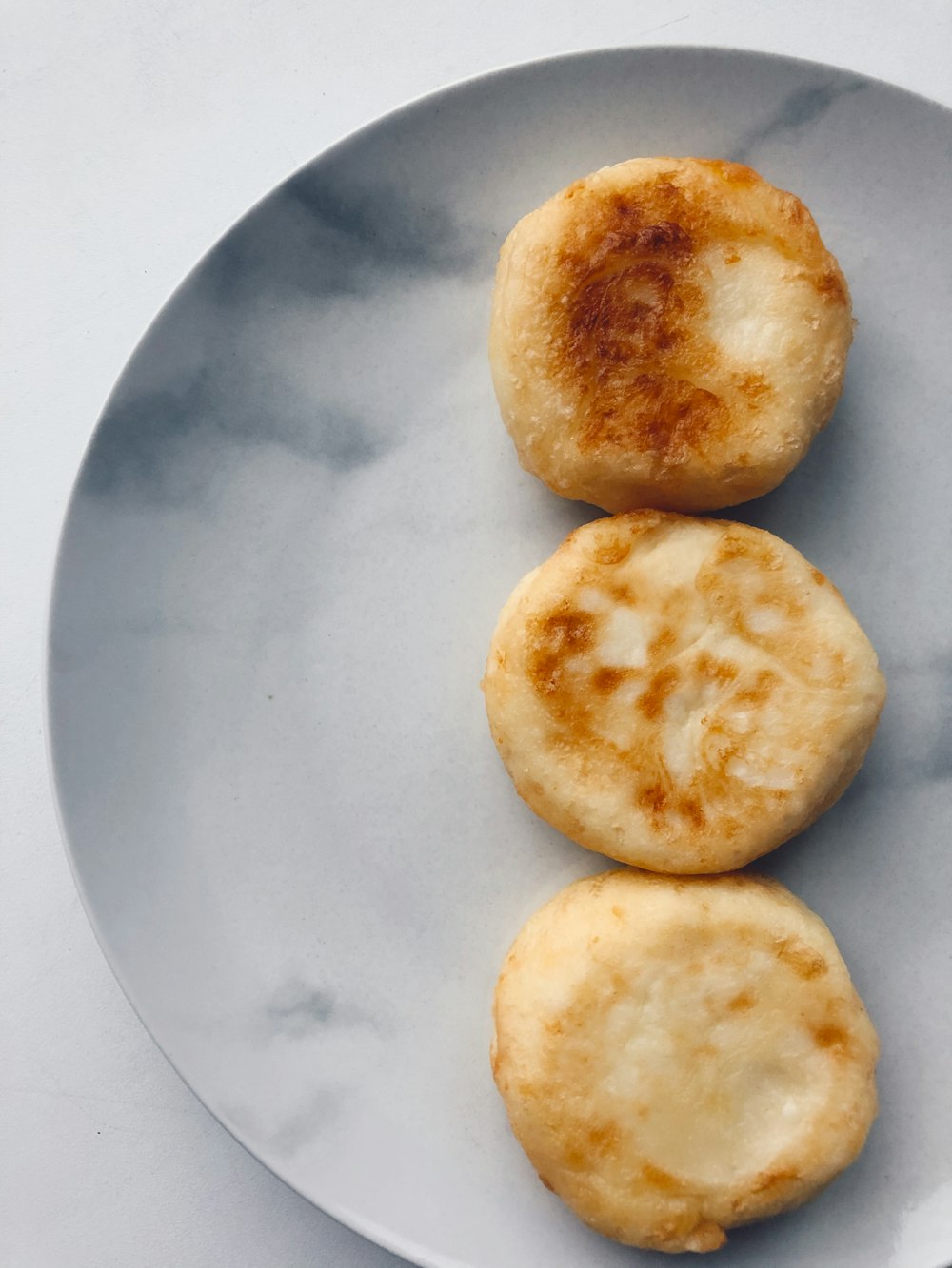 two round bread on white ceramic plate