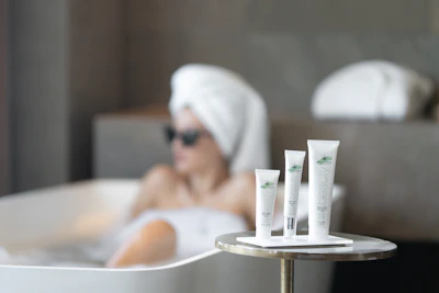 A serene hotel spa setting featuring éclatluxe branded amenities arranged neatly by a plush towel.
