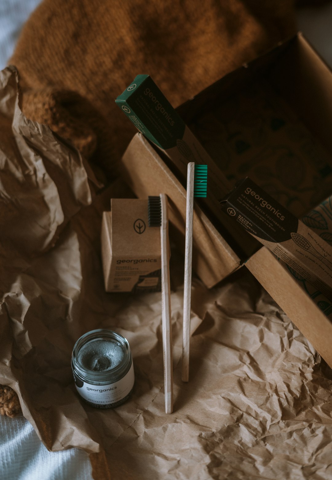 white and green ballpoint pen beside white and black ceramic mug