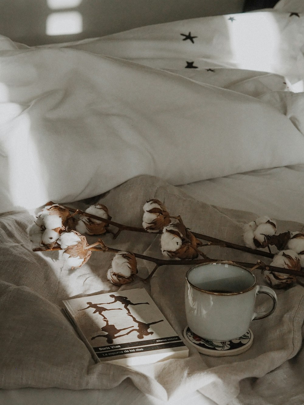 white ceramic mug on white textile